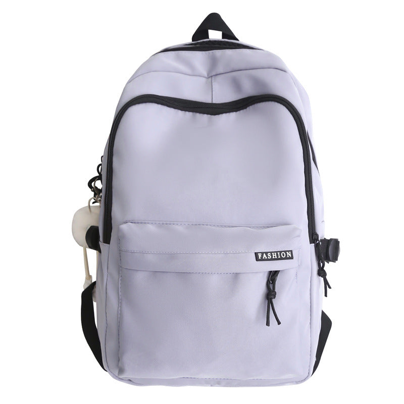 Large capacity burden reduction solid color backpack male junior high school student primary school bag female simple versatile travel backpack