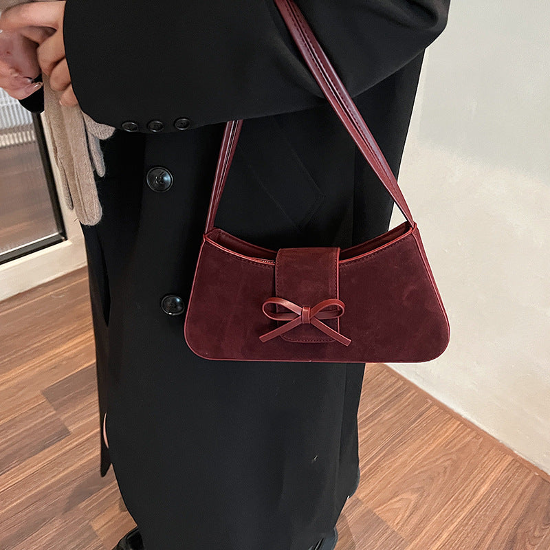 Red bag women's bag 2025 new shoulder baguette bag Korean version fashion minimalist niche bow armpit bag