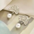Wholesale faux pearl earrings - european & american cross-border retro fashion earrings - light luxury, high-end, unique, asymmetrical stud earrings for women