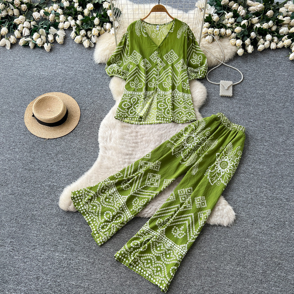 Vacation-ready green floral print two-piece set for women. summer v-neck, slimming wide-leg pants, perfect for both work and play. a stylish and chic outfit