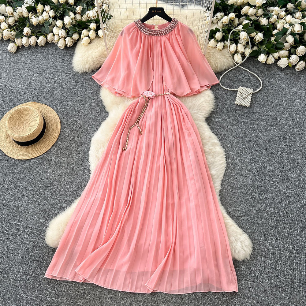 French-style, heavily embellished, beaded and rhinestone-studded, round-neck shawl dress with tie-waist detailing. features a flattering, slimming silhouette and elegant pleated chiffon