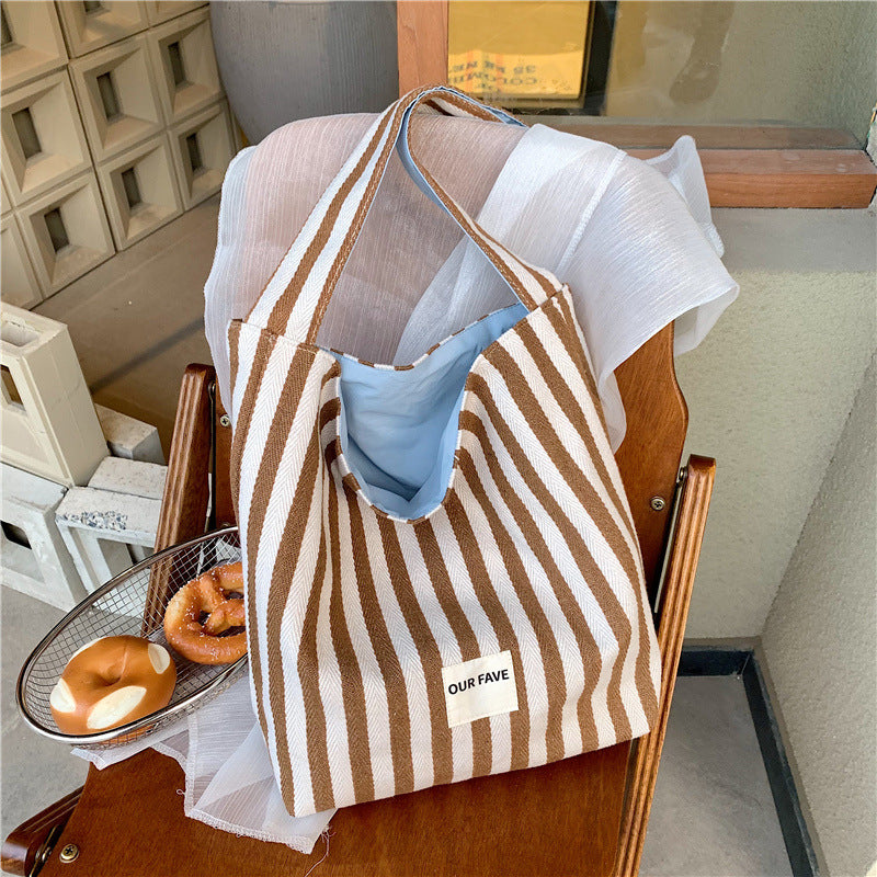 Casual large-capacity striped canvas bag women's 2025 new commuter shoulder bag lightweight versatile tote bucket bag