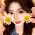 Milky soft, woven raffia daisy flower earrings for women. statement beach earrings designed to flatter the face with a touch of high-end elegance