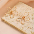 Flower earrings wholesale cross-border exaggerated sense of design earrings women's electroplated alloy versatile cut out line braided earrings