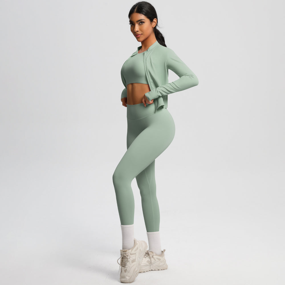 High-waisted, form-fitting yoga pants, a barely-there feel, quick-drying outer layer, and a long-sleeved tee – a women's three-piece activewear set perfect for running and workouts