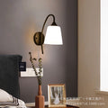 Retro iron curved pole bedside off-white tapered b&b guest room hotel bedroom stairwell casual reading wall lamp