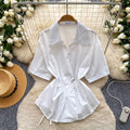 Korean-inspired, design-forward, cinched-waist blouse for women. spring collection, short-sleeved, relaxed-fit, open-front cardigan. elegant and sophisticated, with a touch of french flair