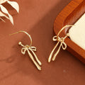 Wholesale bow earrings: european & american cross-border fashion, elegant dangle earrings, minimalist niche design, gold-tone high-end stud earrings