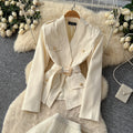Elegant and chic chanel-inspired two-piece set: women's autumn outfit featuring a tie-waist cardigan and mesh skirt
