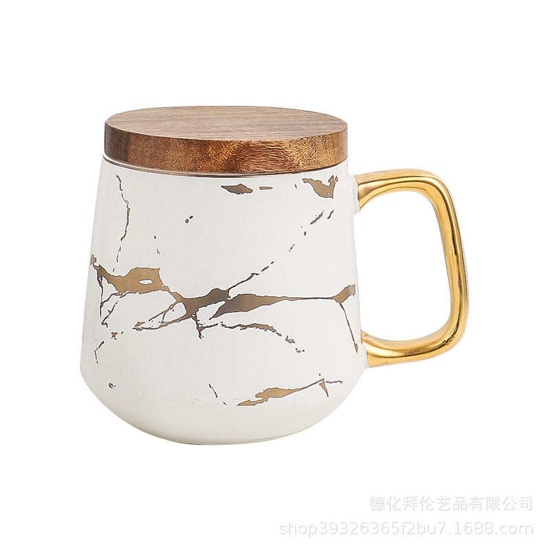 Nordic-inspired ceramic coffee mug, teacup, and saucer set with gold-traced marble pattern and wooden lid