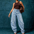 European and american style women's washed denim jeans with metal rivet embellishments, high waist, split seam detail, relaxed fit, and wide leg design
