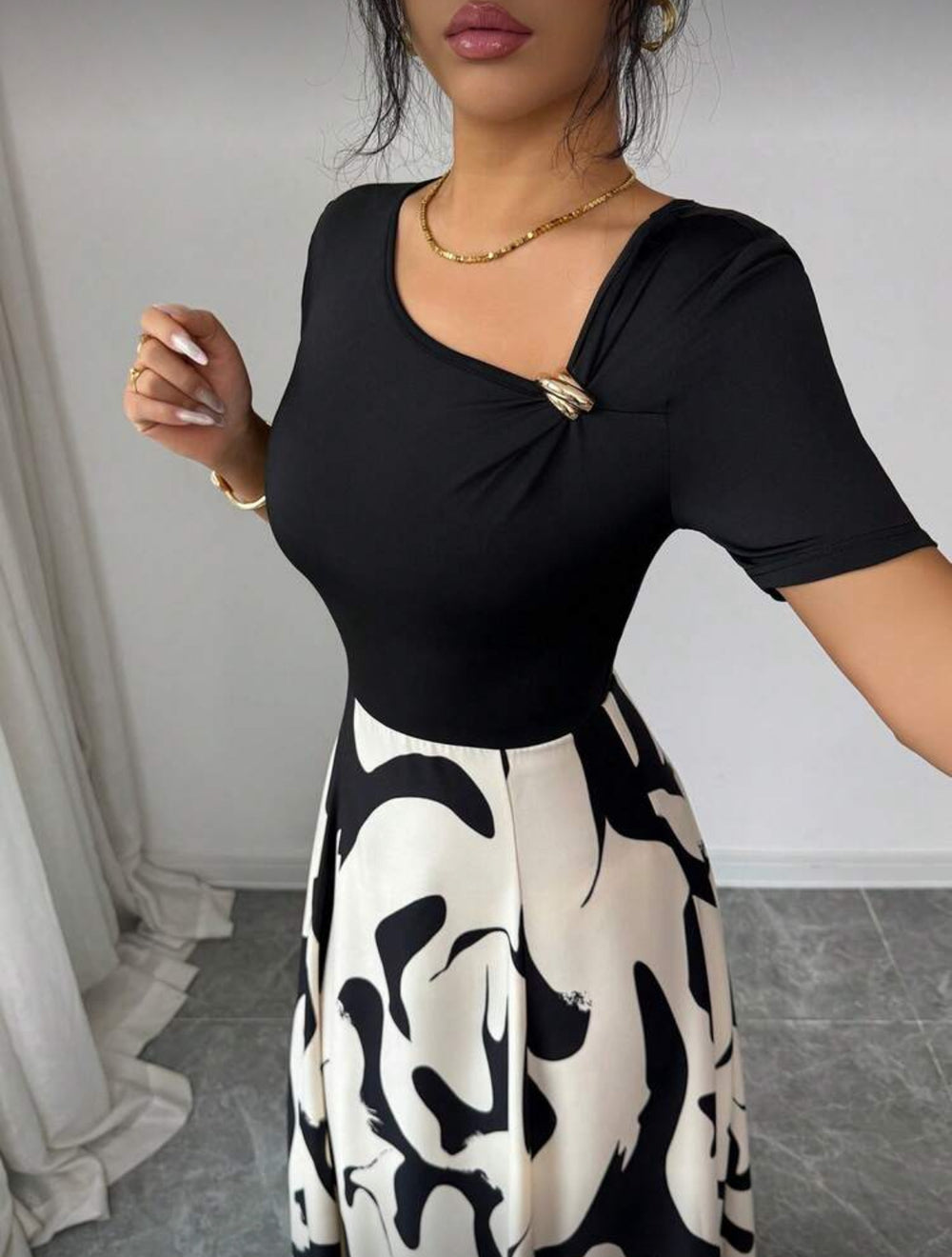 women's v-neck a-line dress with cinched waist, black and white abstract print, and metal buckle detail – elegant and versatile