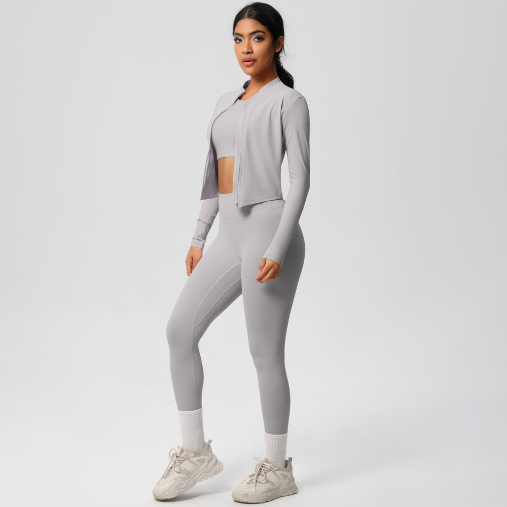 High-waisted, form-fitting yoga pants, a barely-there feel, quick-drying outer layer, and a long-sleeved tee – a women's three-piece activewear set perfect for running and workouts