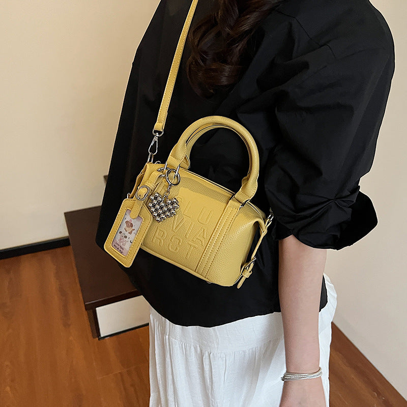 Fashion niche high-end sense embossed letter pillow bag 2025 new summer versatile color casual messenger bag