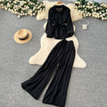 Sophisticated, niche design two-piece set for women: a long-sleeved, tie-waist blouse with a bow detail, paired with high-waisted, wide-leg pants