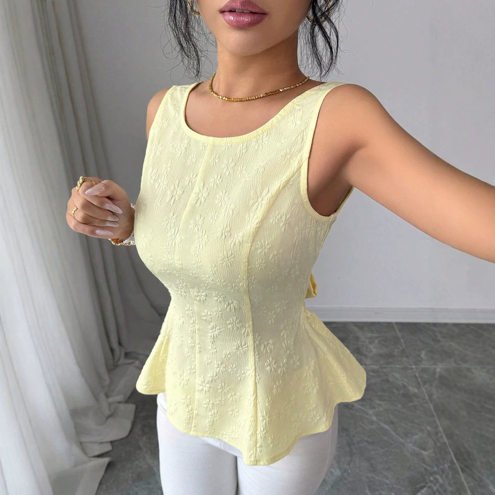 Sleeveless, waist-cinching top for women, featuring a ruffled hem, open back, and bow tie closure. a versatile and stylish piece perfect for everyday wear