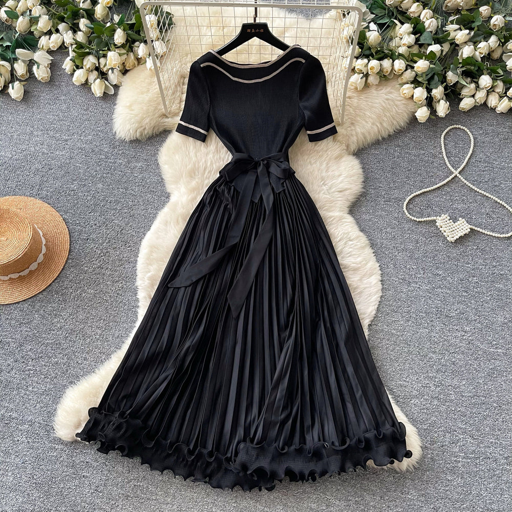 Sophisticated and elegant green pleated dress for women. short-sleeved, waist-cinching, pleated maxi dress, perfect for the office or a sophisticated socialite look