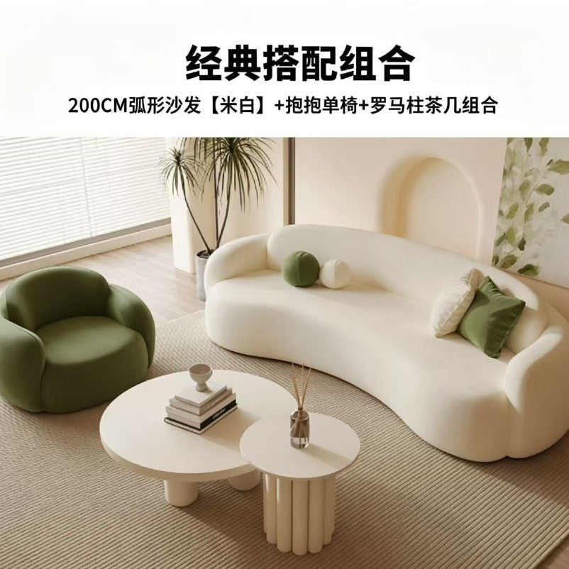 Curved, uniquely shaped, cream-toned sofa – a creative and sophisticated addition to clothing stores, beauty salons, office break rooms, and reception areas