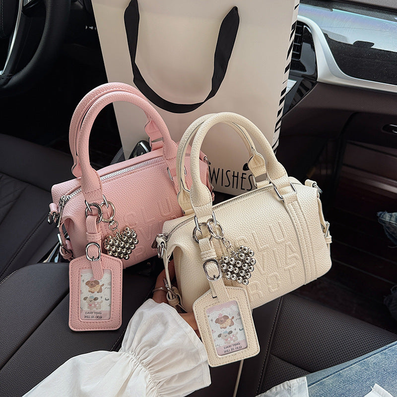 Fashion niche high-end sense embossed letter pillow bag 2025 new summer versatile color casual messenger bag