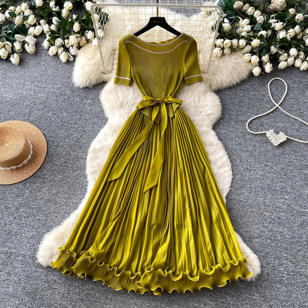 Sophisticated and elegant green pleated dress for women. short-sleeved, waist-cinching, pleated maxi dress, perfect for the office or a sophisticated socialite look