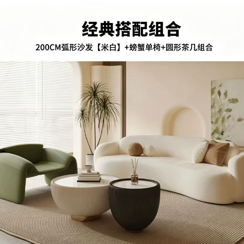 Curved, uniquely shaped, cream-toned sofa – a creative and sophisticated addition to clothing stores, beauty salons, office break rooms, and reception areas