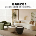 Curved, uniquely shaped, cream-toned sofa – a creative and sophisticated addition to clothing stores, beauty salons, office break rooms, and reception areas