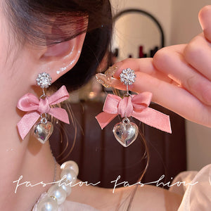 "instagram-worthy, 'rich girl' style pink bow and heart pendant earrings – unique, sweet, and perfect for vacation. wholesale available."