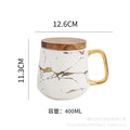 Nordic-inspired ceramic coffee mug, teacup, and saucer set with gold-traced marble pattern and wooden lid