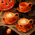 Creative halloween-themed ceramic cup and saucer set, featuring an irregular design with pumpkin and bat motifs. perfect for coffee or tea
