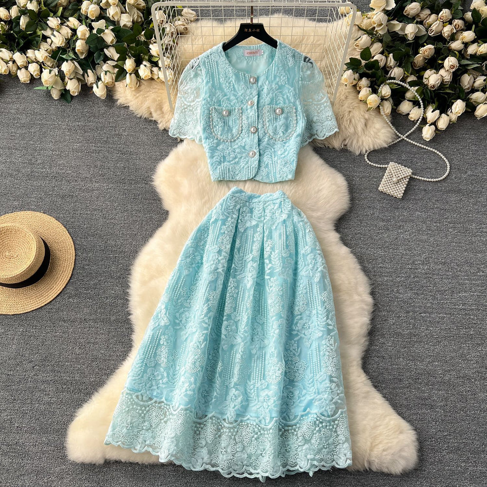 High-end, sophisticated, and feminine two-piece set for women. features a french-style lace crochet blouse with puff sleeves and a high-waisted, slimming midi skirt