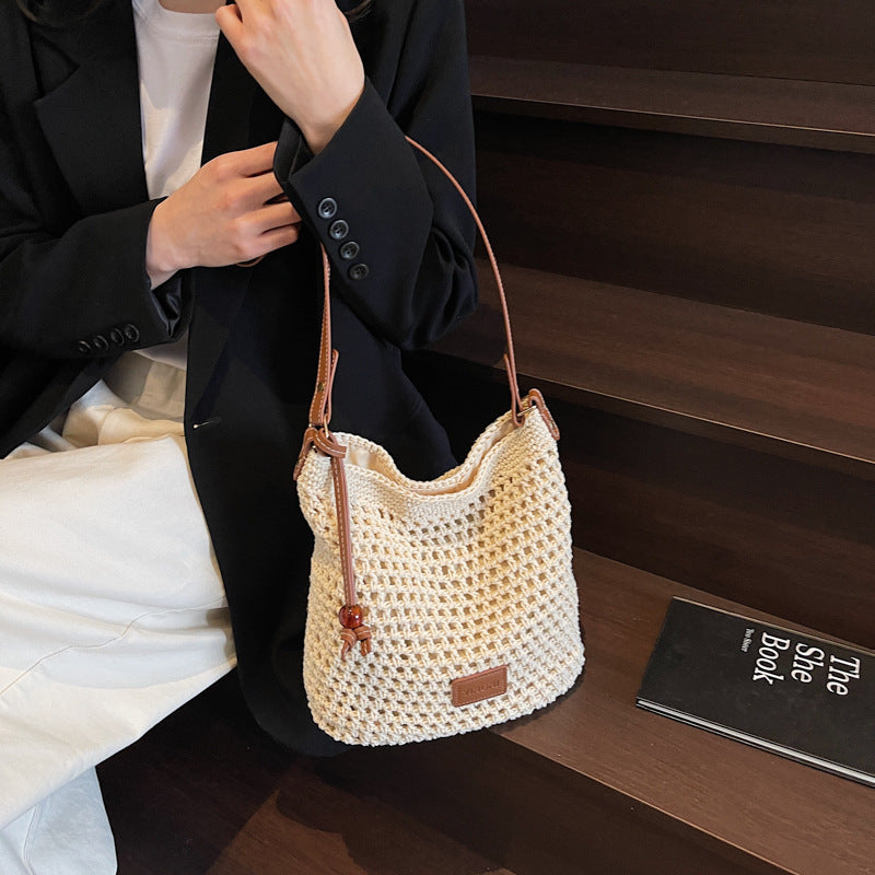 Holiday knitted bag women's 2025 summer new commuter shoulder messenger bag hollow woven bucket bag wholesale