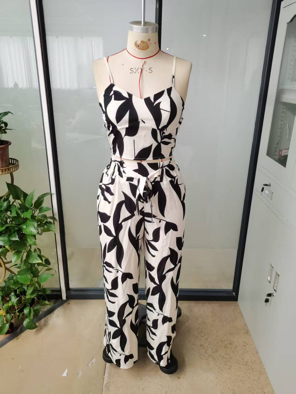 Two-piece set featuring a spaghetti strap elastic tank top and wide-leg tie-front pants,  early autumn european and american style