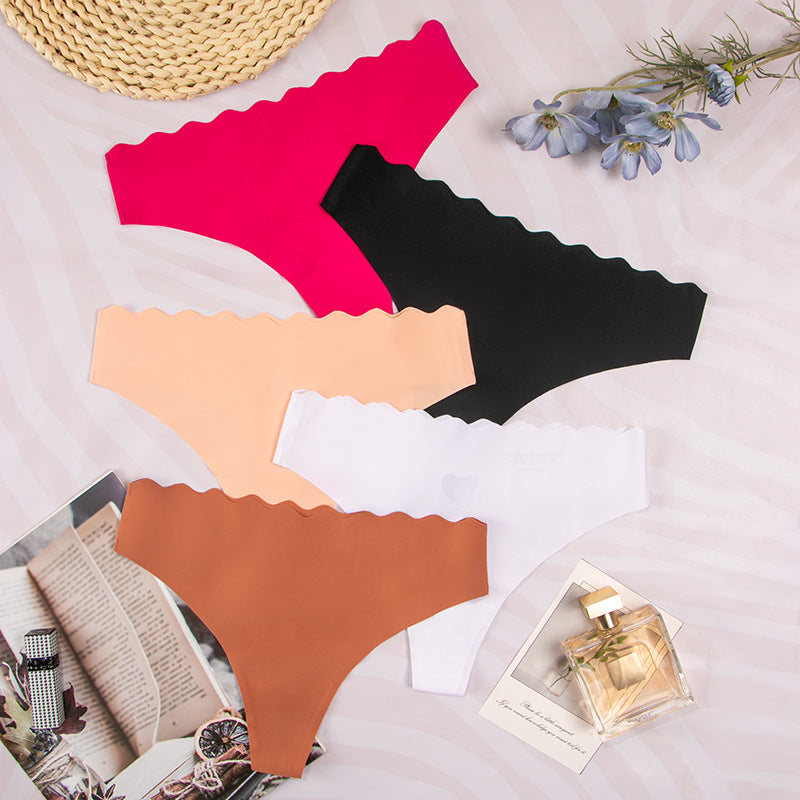 European and american  low-waist seamless ice silk underwear one-piece adhesive pure color cut out wavy waist women's underwear