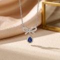 8454 blue teardrop bow steel-colored necklace