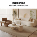 Curved, uniquely shaped, cream-toned sofa – a creative and sophisticated addition to clothing stores, beauty salons, office break rooms, and reception areas