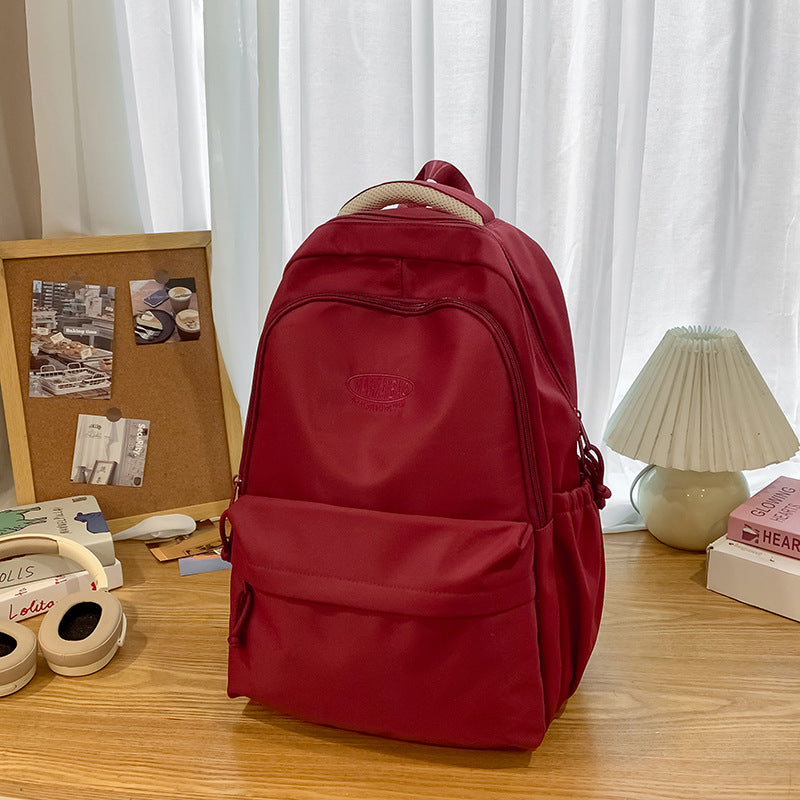 New schoolbag large capacity water-resistant embroidered backpack for junior and senior high school students - solid color, simple, and cute design