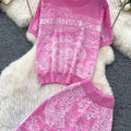 Vacation-ready pink floral print letter print casual two-piece set for women, featuring a summer short-sleeved top and high-waisted wide-leg pants. a stylish and versatile outfit perfect for both work and play