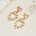 European and american cross-border casual sweet heart pearl earrings - light luxury, high-end, elegant, versatile, hollow heart stud earrings for women