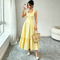 new european and american style cream yellow square neck sleeveless dress with pearl button detail, cinched waist, and pleated midi skirt