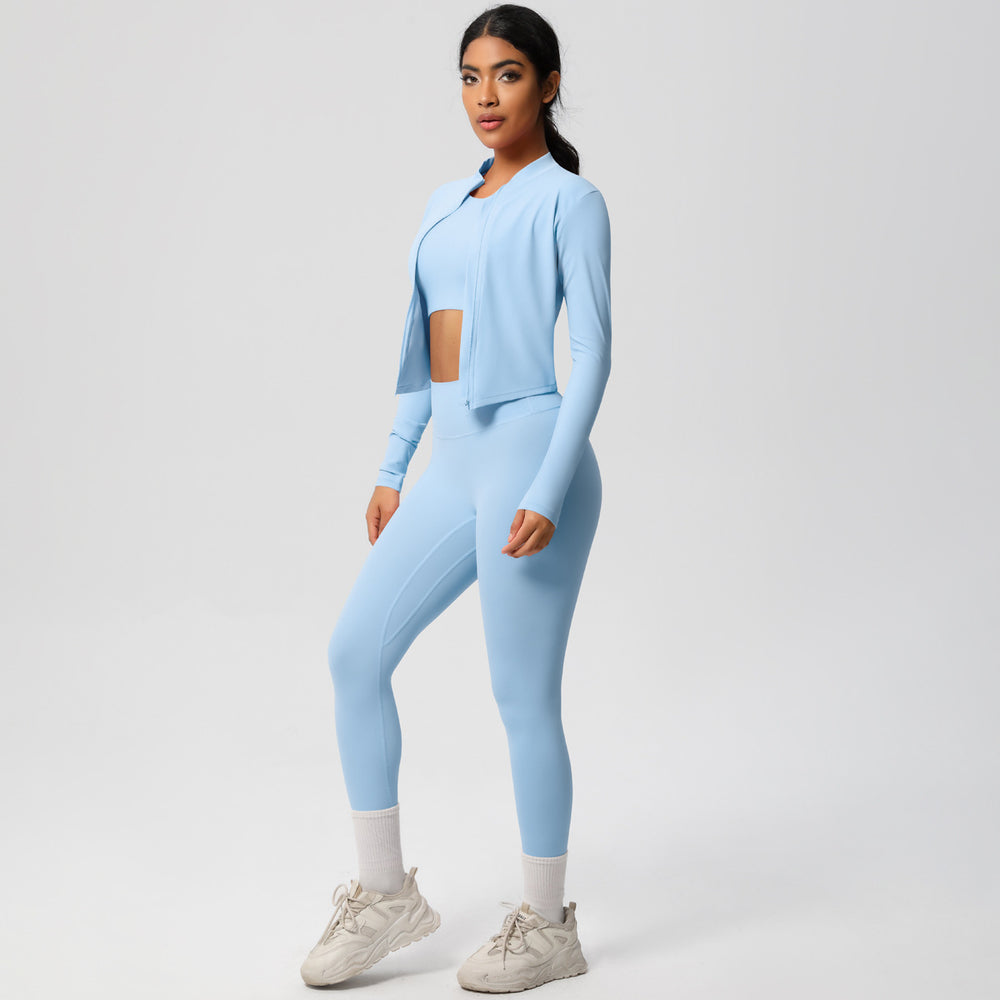 High-waisted, form-fitting yoga pants, a barely-there feel, quick-drying outer layer, and a long-sleeved tee – a women's three-piece activewear set perfect for running and workouts