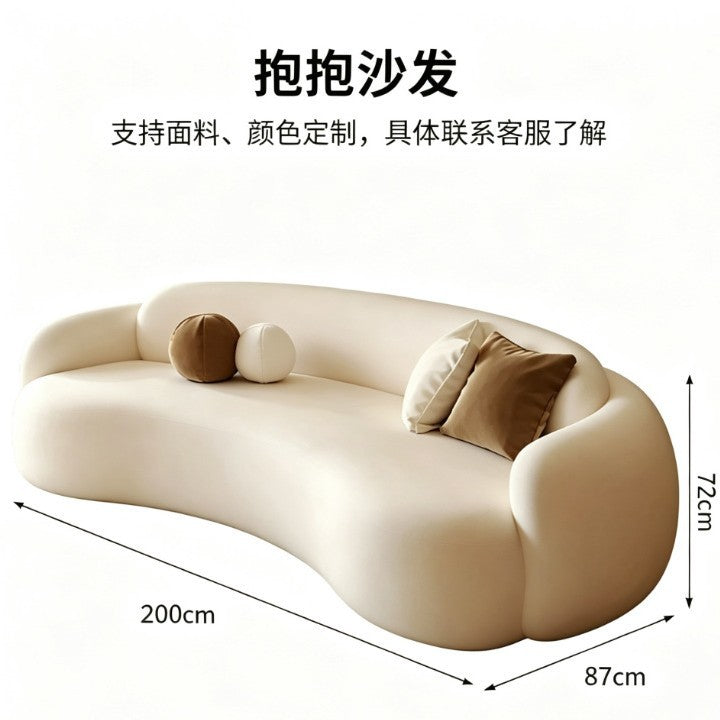 Curved, uniquely shaped, cream-toned sofa – a creative and sophisticated addition to clothing stores, beauty salons, office break rooms, and reception areas