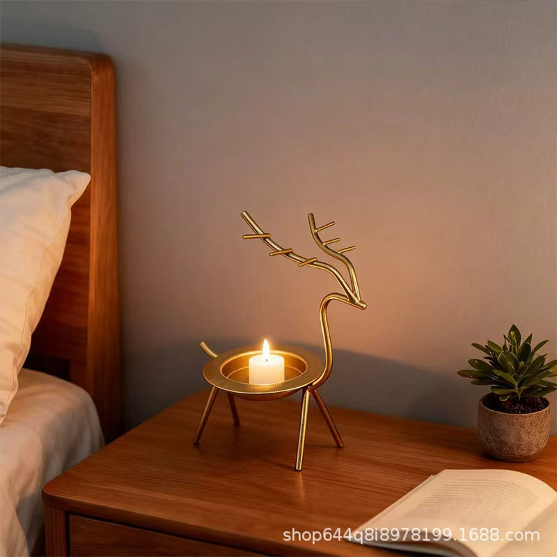 French-chic holiday decorations: deer and elk shaped iron candle holders, golden decorative pieces for restaurant tabletops