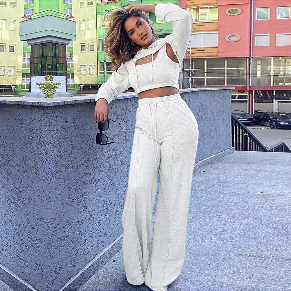 S390416 Cross-border explosive wholesale European and American casual hooded hollow sweater solid color suspender trousers three-piece set women