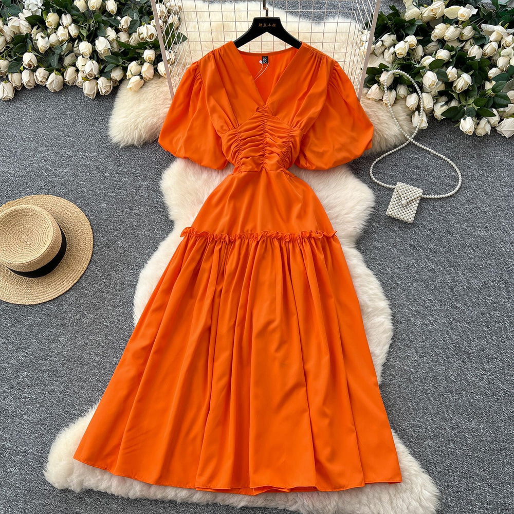 French-inspired, niche v-neck dress with ruched waist, puff sleeves, and a flowy, a-line silhouette. perfect for a slimming and elegant summer look