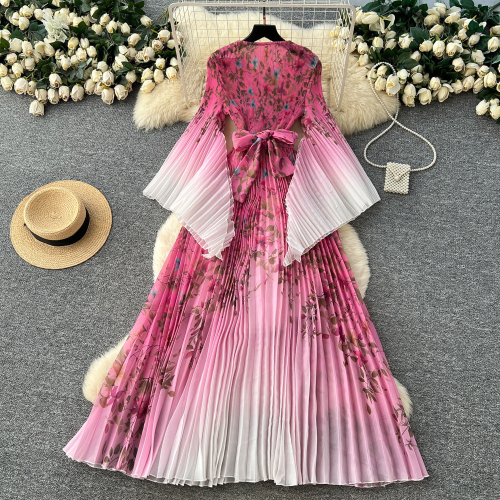 Elegant and stylish flared-sleeve printed dress for women, featuring a cinched waist, pleated detailing, batwing sleeves, and a full, flowing skirt. a sophisticated and versatile dress perfect for the office