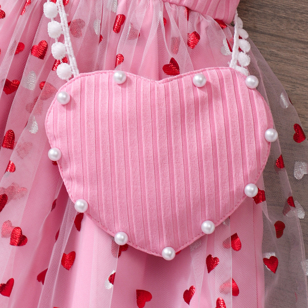 Girls' ribbed knit dress with heart-shaped mesh sleeves and pearl accents, includes crossbody bag