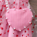 Girls' ribbed knit dress with heart-shaped mesh sleeves and pearl accents, includes crossbody bag