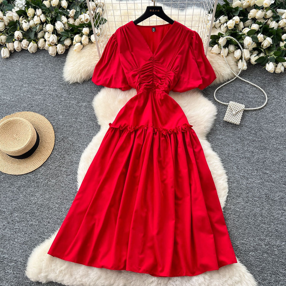 French-inspired, niche v-neck dress with ruched waist, puff sleeves, and a flowy, a-line silhouette. perfect for a slimming and elegant summer look