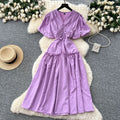French-inspired, niche v-neck dress with ruched waist, puff sleeves, and a flowy, a-line silhouette. perfect for a slimming and elegant summer look