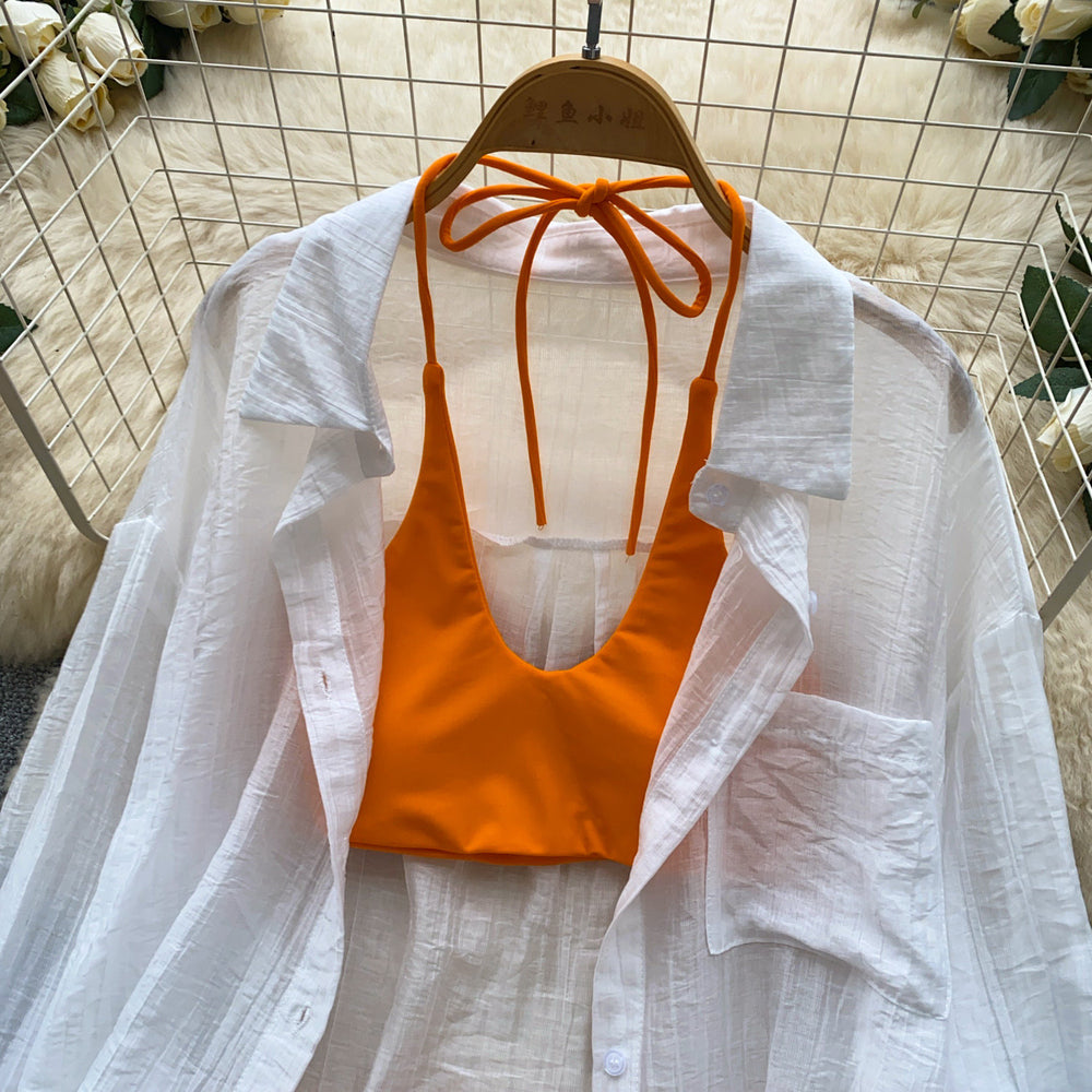 Vacation-ready bikini set for the hot girl summer look: orange cami top, floral print skirt, and sun-protective cardigan – a chic and stylish three-piece outfit